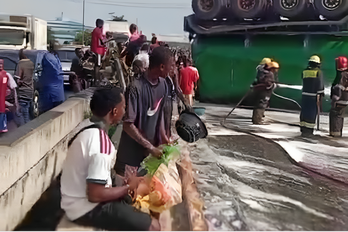 Residents scoop spilled cooking oil from roadside after tanker crash at Ojota, LASTMA warns of health risks