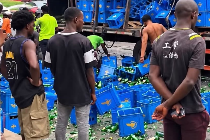 Nigerians ignore broken bottles, rush to drink spilled beer after van crashes in Lagos