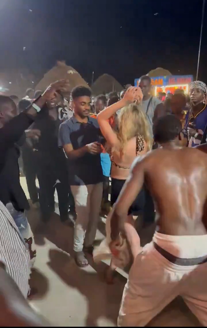 White Lady Draws Attention As She Joins A Crowd Of Black Men In Celebration(Pix)
